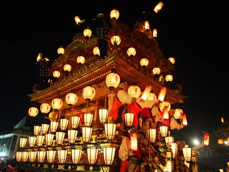 An ornate festival float covered in glowing paper lanterns at night, Chichibu Night Festival