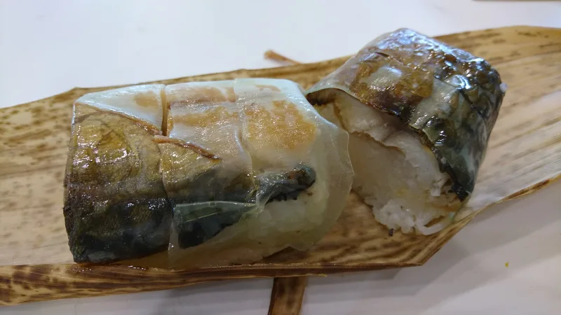 Pieces of grilled-mackerel pressed sushi, a Kansai-style sushi, served on a bamboo leaf