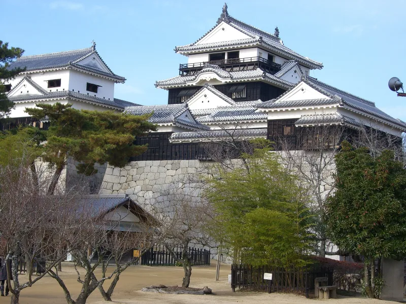 Matsuyama Castle tower in winter, above its stone walls