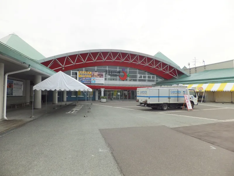 Entrance building with a red arched roof at Akita Furusato Mura