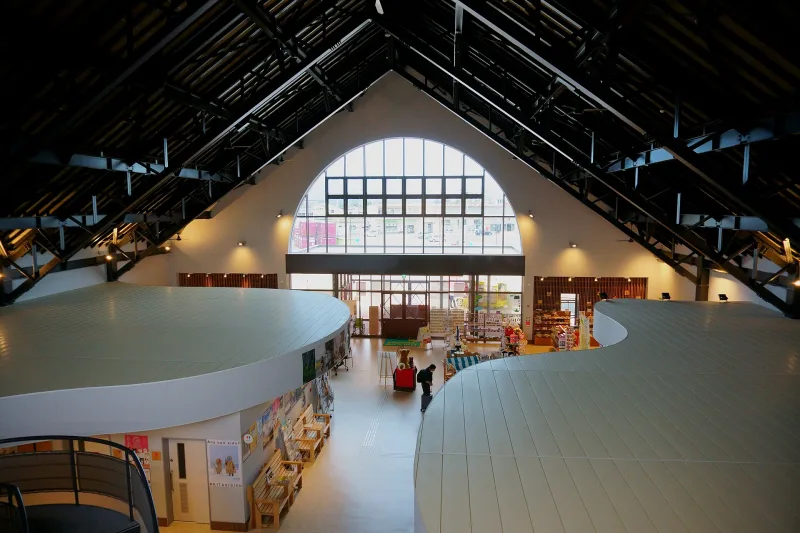 Bright interior hall of the Akita Inu no Sato visitor center with shop counters