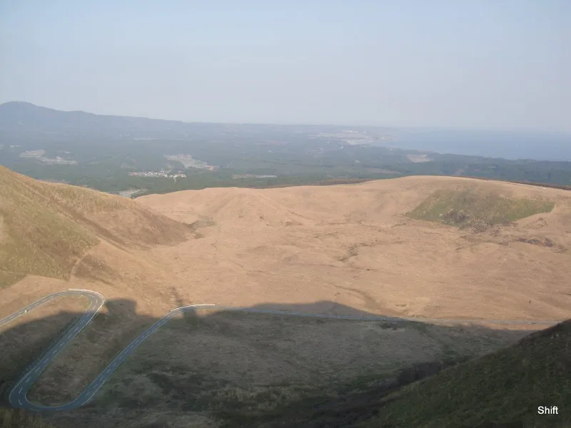Grassy slopes and a winding road seen from Mount Kanpu on the Oga Peninsula