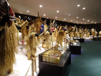 Rows of straw-clad Namahage figures with different masks on display inside the Namahage Museum