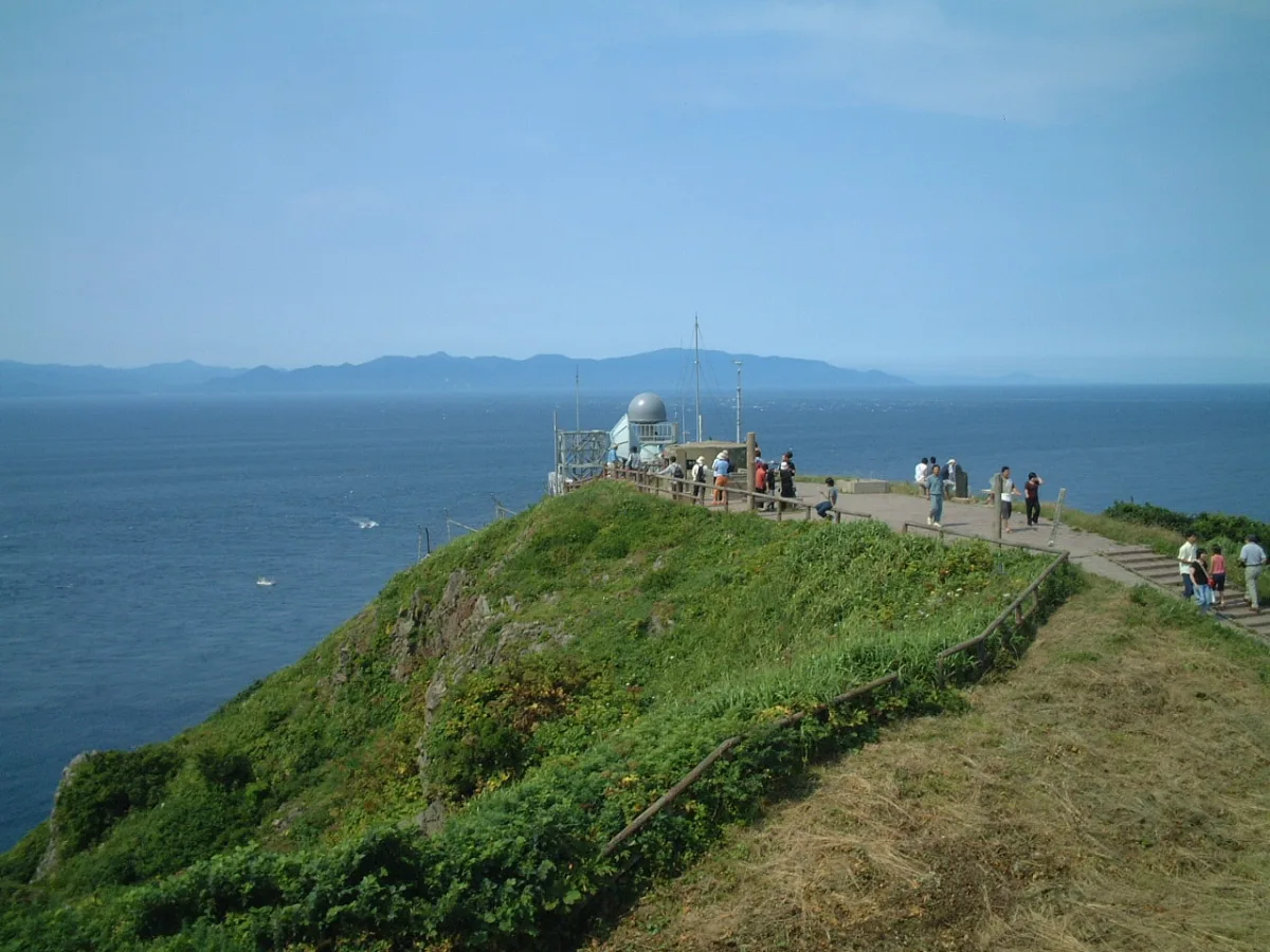 Grassy tip of Cape Tappi with the Tsugaru Strait and Hokkaido's coast on the horizon