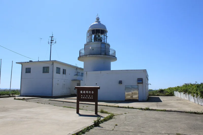 White round Tappizaki Lighthouse under a clear blue sky