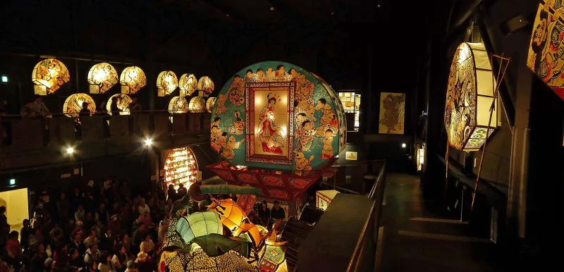 Hall full of illuminated neputa lanterns seen from the upper gallery at Neputa Mura