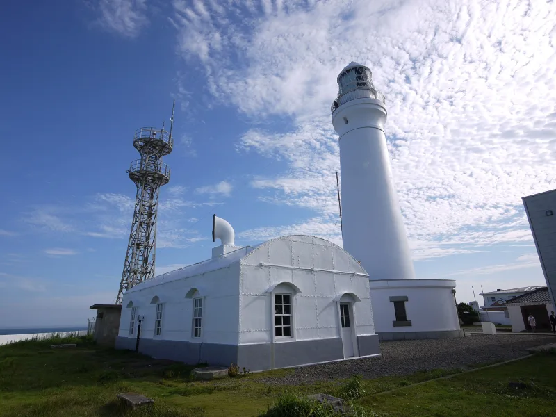 Inubosaki Lighthouse and the white former fog signal building under a blue sky