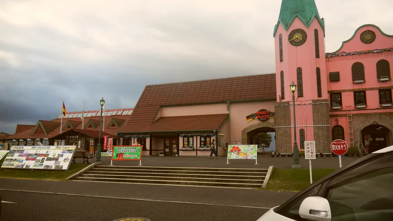 Pink German-style building with a clock tower at Tokyo German Village