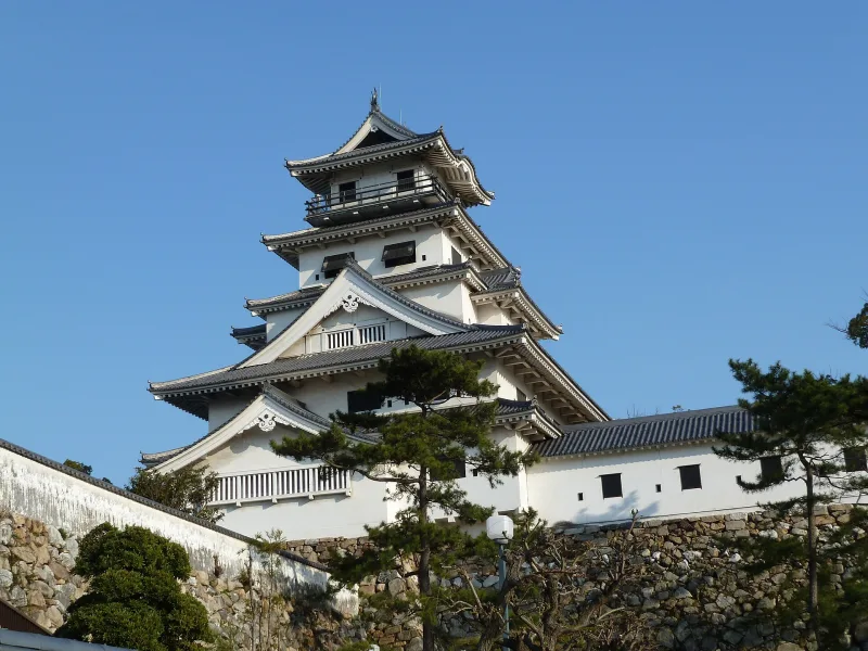 Five-tiered white keep of Imabari Castle against a blue sky