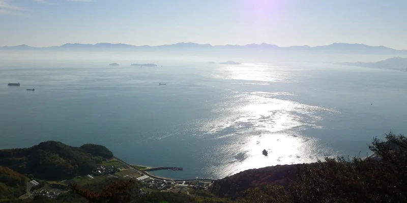 Hazy view over the Seto Inland Sea toward distant mountains from Mount Kiro