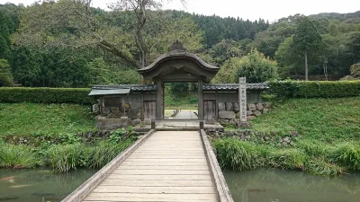 The Karamon gate and wooden bridge at the Asakura residence ruins in Ichijodani