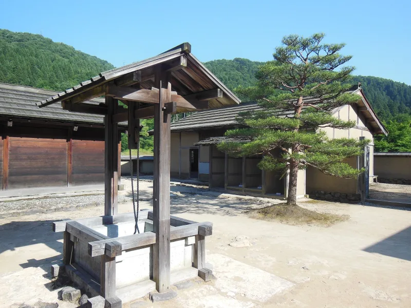 Reconstructed samurai-era street with earthen walls and wooden houses at Ichijodani
