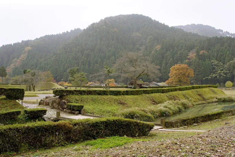 Foundation stones of the Asakura residence laid out in a green valley in autumn
