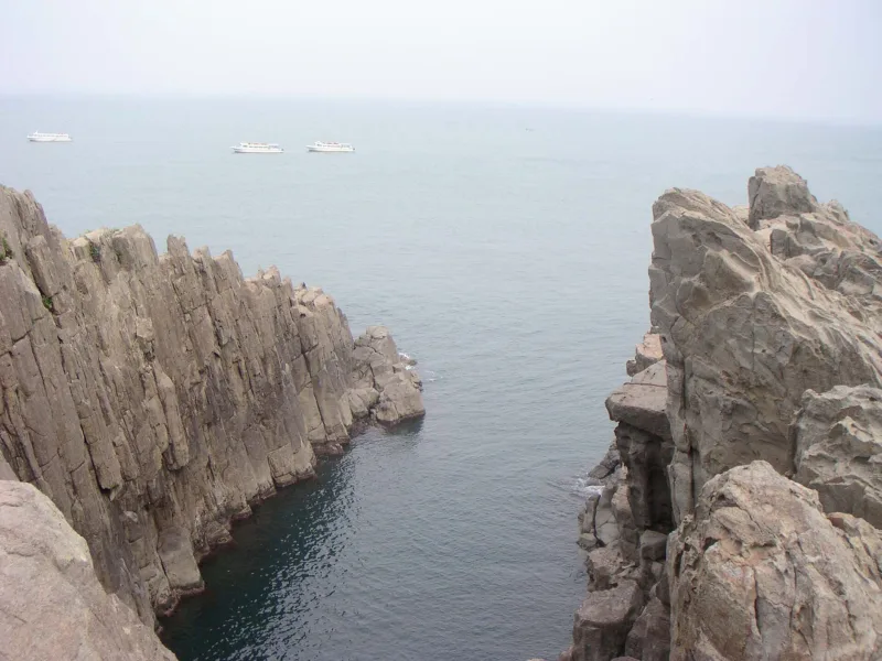 The Oike inlet at Tojinbo, a narrow channel of calm sea between sheer rock cliffs