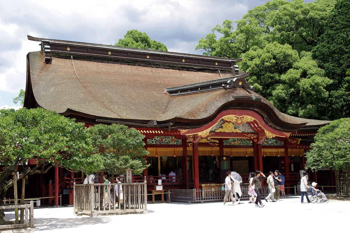 The ornate main hall of Dazaifu Tenmangu with its sweeping bark roof and red and gold front