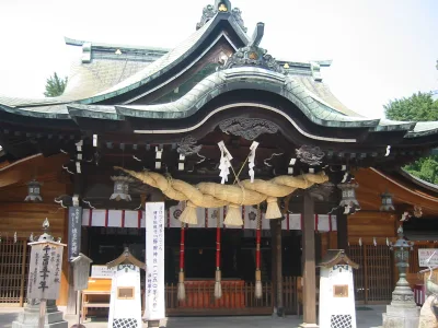 Worship hall of Kushida Shrine in Hakata with a thick sacred rope hanging under the curved roof