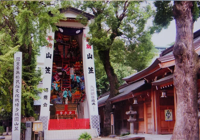 Towering decorated Yamakasa festival float on display in the grounds of Kushida Shrine