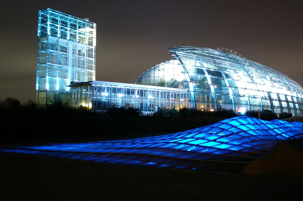 The glass-roofed Aquamarine Fukushima aquarium building lit up in blue at night