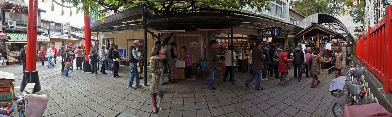 Wide view of the busy shopping street leading to Chiyobo Inari Shrine