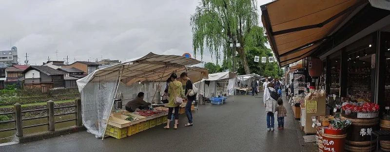 Tented stalls selling local produce beside the river at the Miyagawa Morning Market
