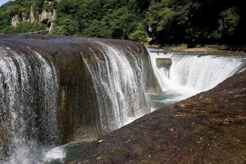 Close view of the curtain of water falling into the gorge at Fukiware Falls