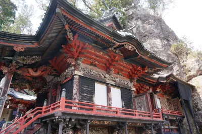 Ornate main hall of Haruna Shrine built against a huge rock face