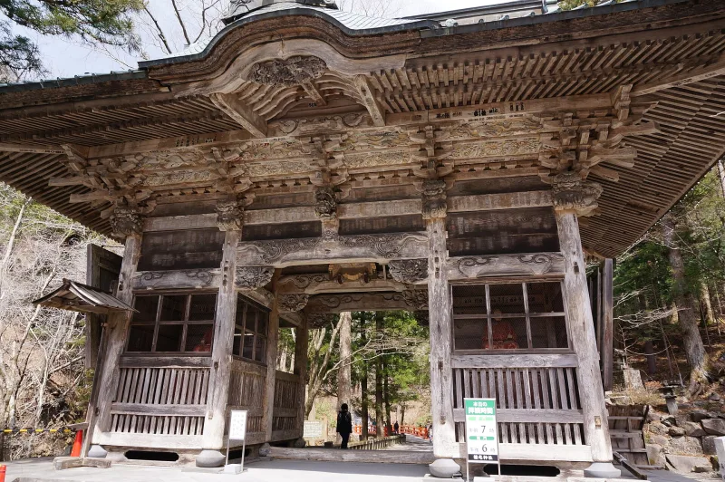 Old unpainted wooden Zuishinmon gate on the approach to Haruna Shrine