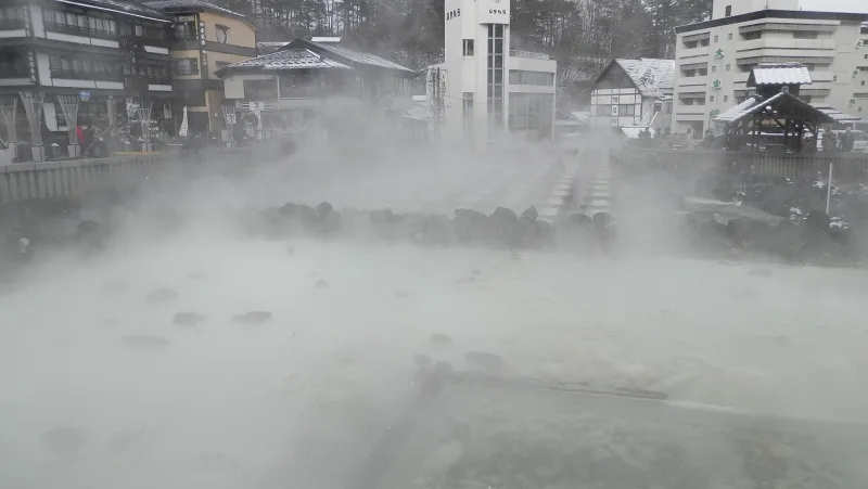 Steam rising from the wooden channels of Yubatake in Kusatsu Onsen