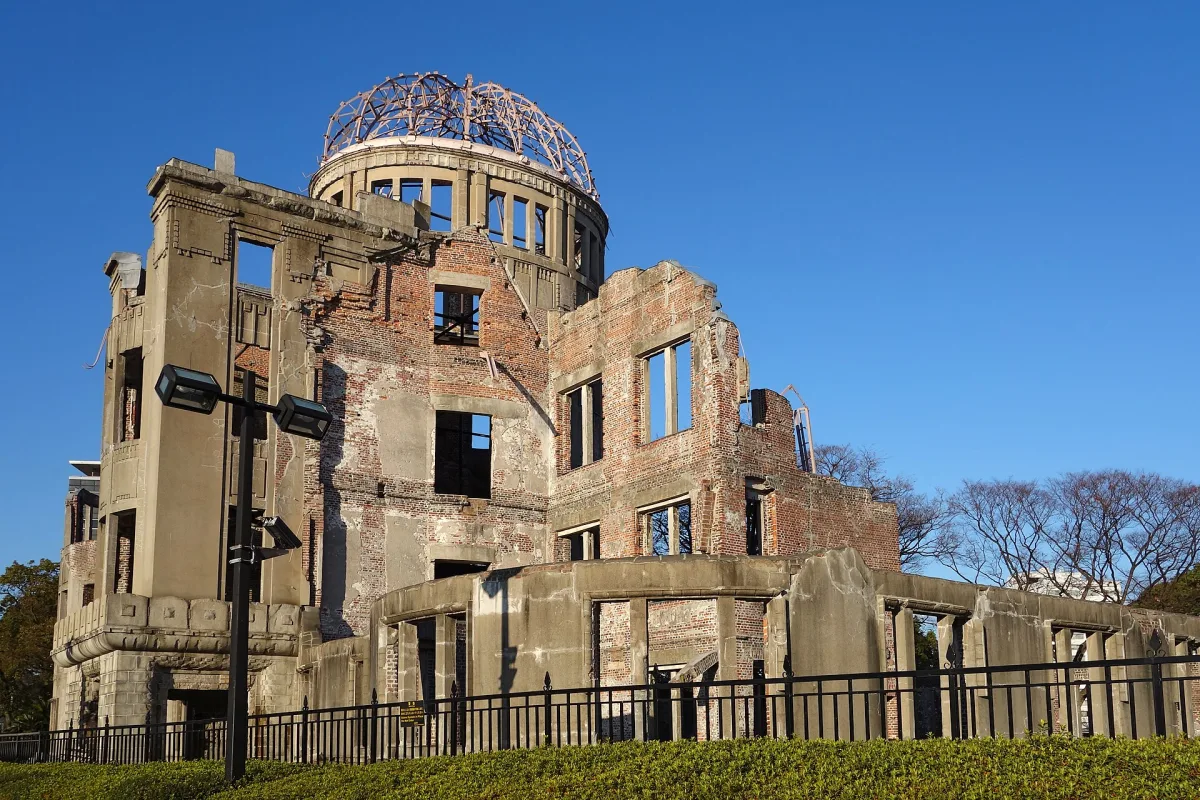 The ruined brick building and bare steel dome frame of the Atomic Bomb Dome in Hiroshima under a blue sky