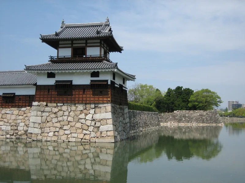 The reconstructed Taiko-yagura turret on stone walls beside the castle moat