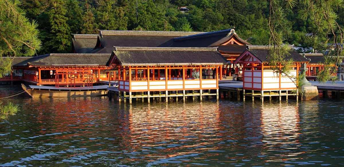 Vermilion halls and corridors of Itsukushima Shrine standing over the sea at high tide