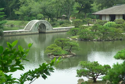 The arched stone Koko-kyo bridge crossing the pond at Shukkeien Garden in Hiroshima