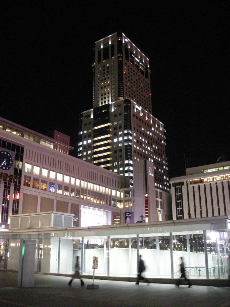 JR Tower lit up at night above Sapporo Station