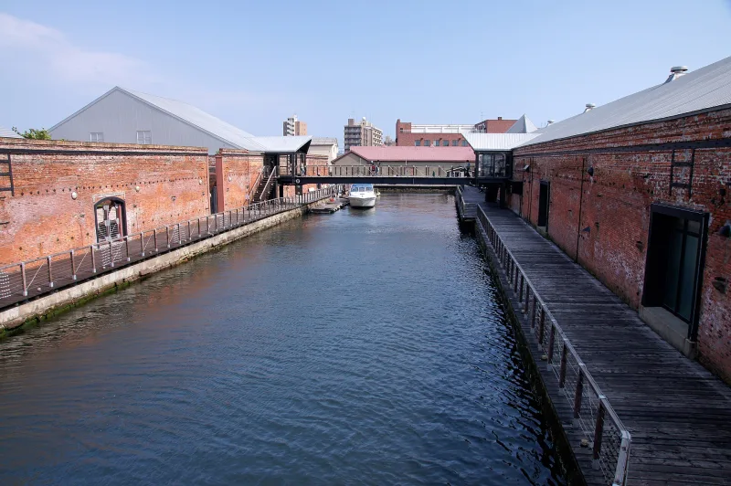 Canal running between two red brick warehouse buildings in Hakodate's bay area