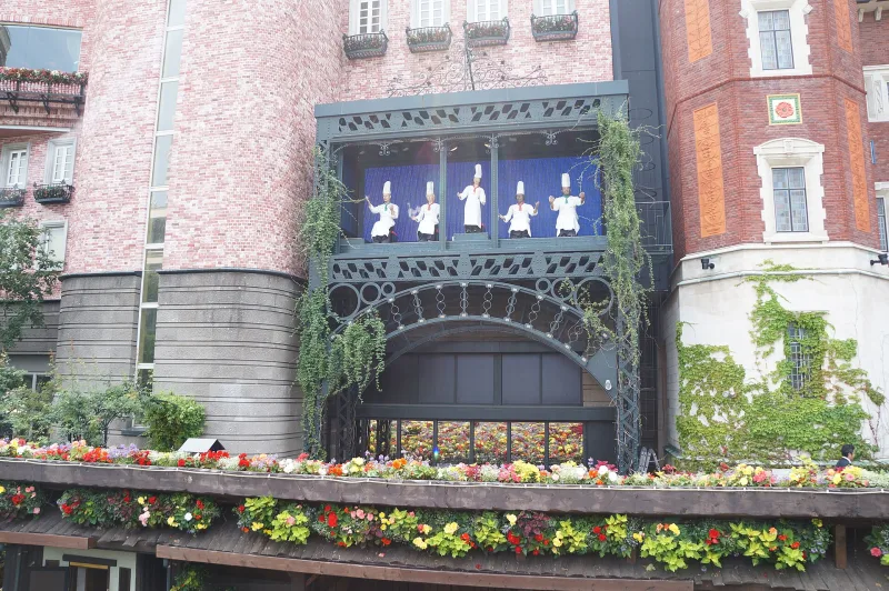 Brick facade at Shiroi Koibito Park with a balcony of figures and flower boxes