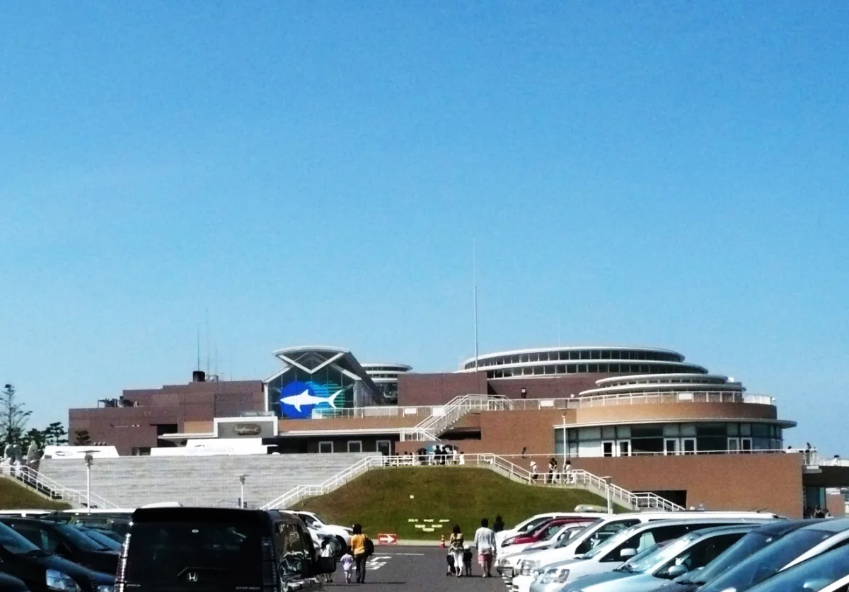 Exterior of Aqua World Oarai aquarium with its round building and shark logo