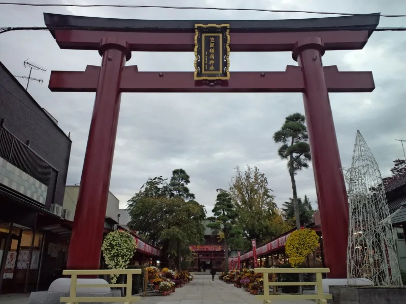 The large red torii gate at the entrance to Kasama Inari Shrine