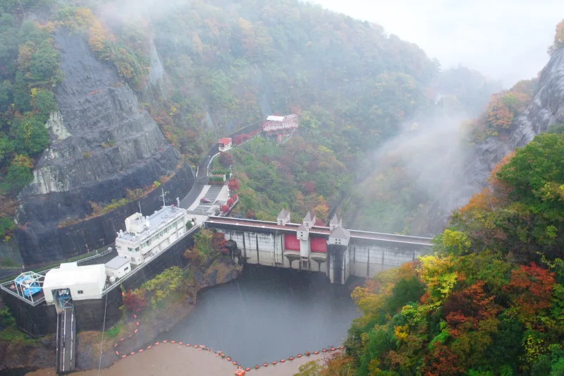 Ryujin Dam and autumn-coloured ravine seen from the suspension bridge in mist