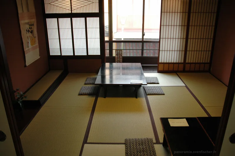 Tatami room with paper screens inside a historic teahouse in the Higashi Chaya District