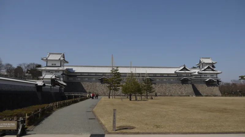 The long Gojikken Nagaya storehouse linking two turrets across the lawn of Kanazawa Castle Park