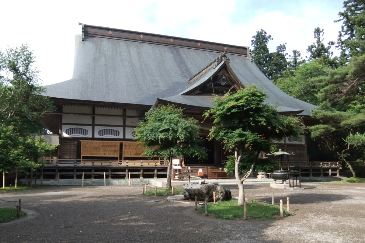 Main hall of Chuson-ji Temple in Hiraizumi surrounded by green trees