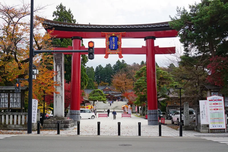 Large red torii gate at the entrance to Morioka Hachimangu Shrine in autumn