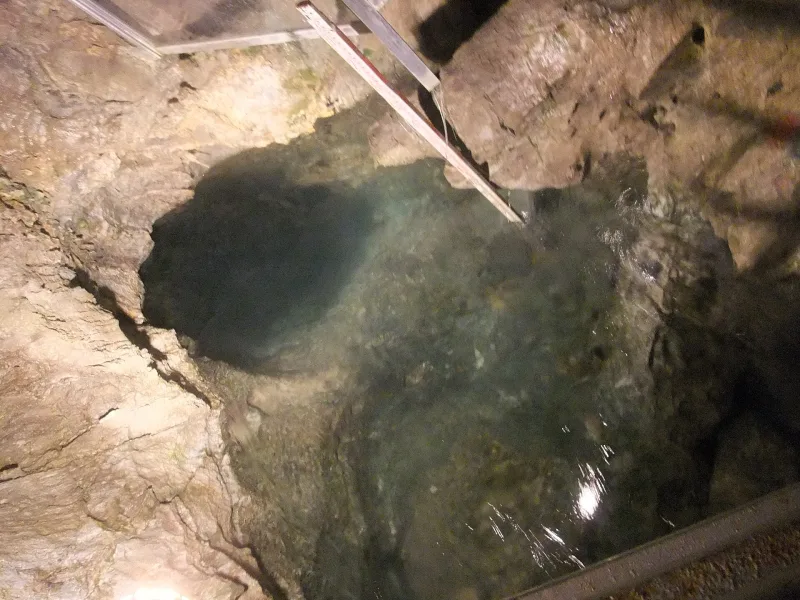 Clear water welling up among rocks inside the Ryusendo caves