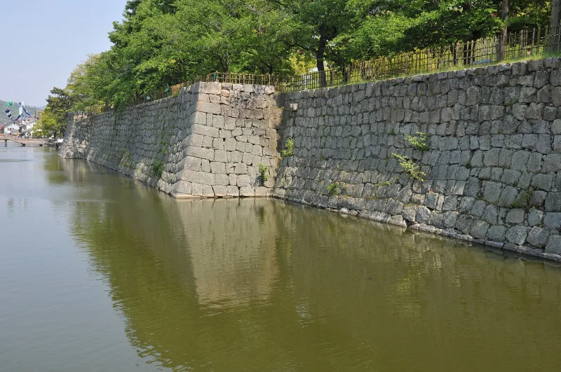 Stone walls of Marugame Castle rising straight from the moat