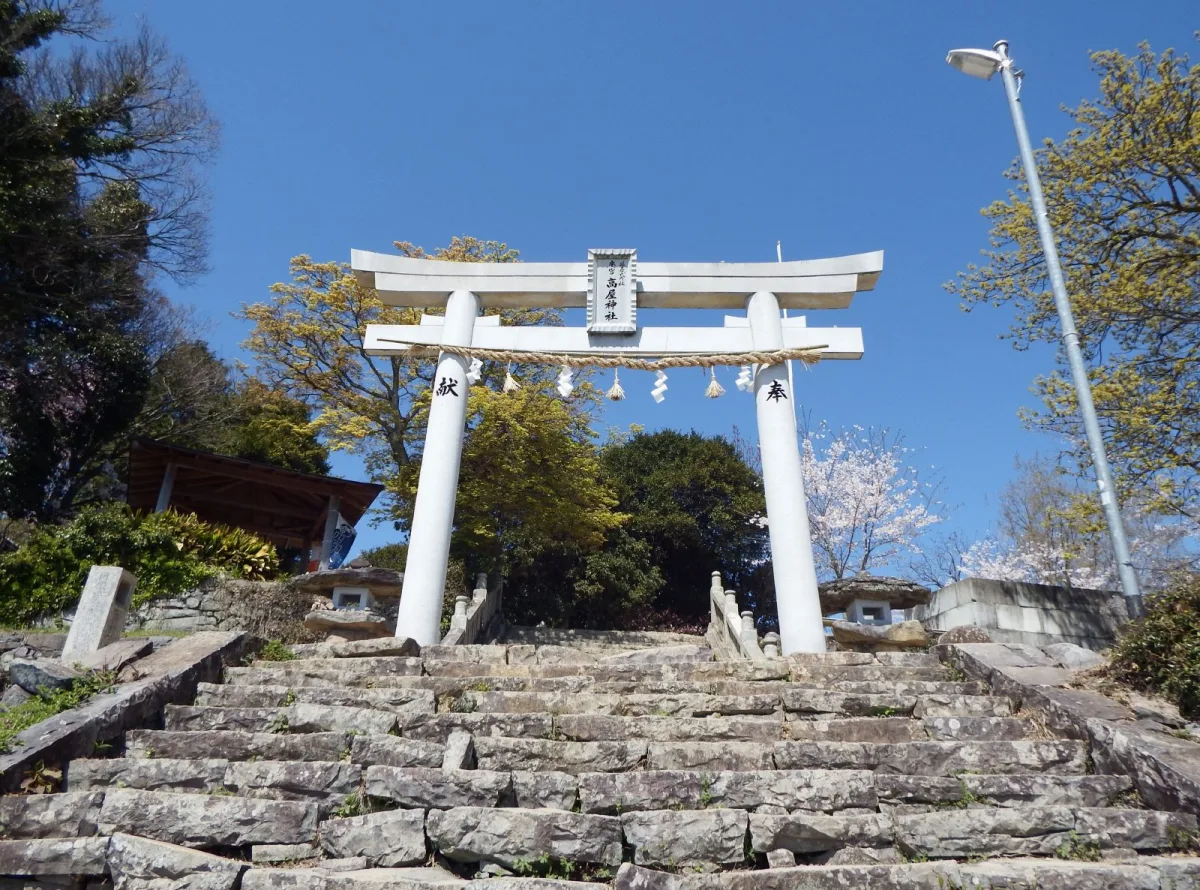 Stone torii with a sacred rope beside the steps at Takaya Shrine’s Main Shrine.
