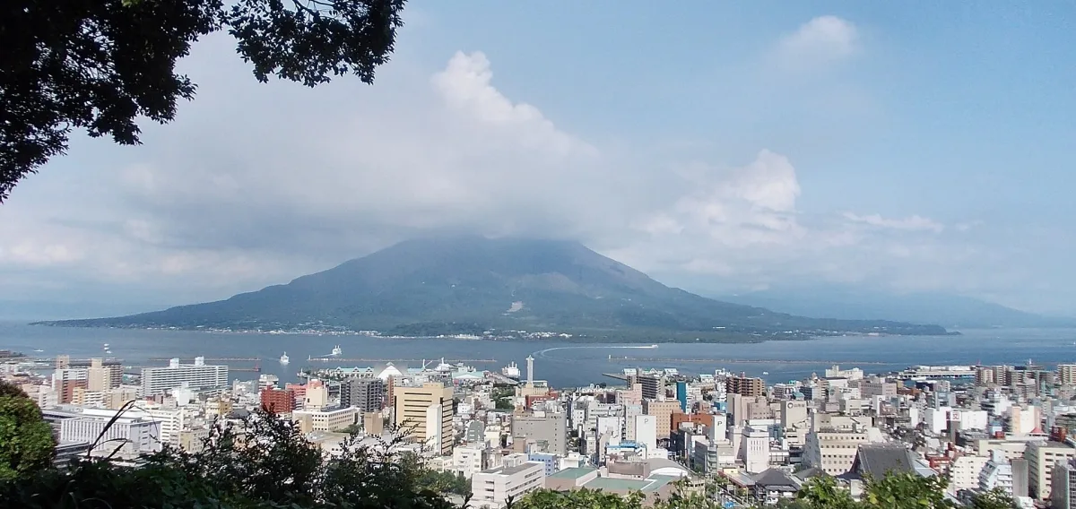 Sakurajima volcano across Kinko Bay behind central Kagoshima, seen from Shiroyama