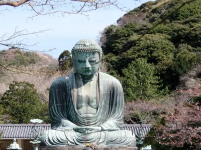 The bronze Great Buddha of Kamakura seated outdoors at Kotoku-in, seen from the front