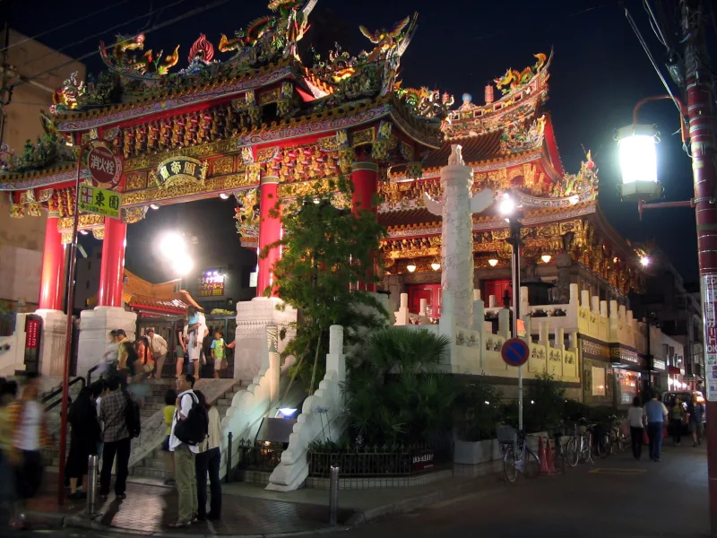 A brightly decorated Chinese temple in Yokohama Chinatown lit up at night