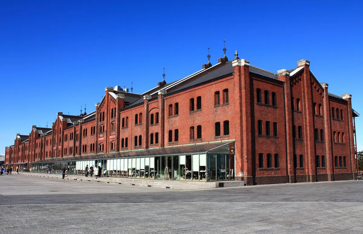 The long red-brick Building No. 2 of the Yokohama Red Brick Warehouse under a clear blue sky