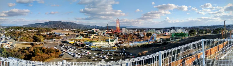 Panoramic view over the Greenland amusement park rides and car parks from a hilltop lookout